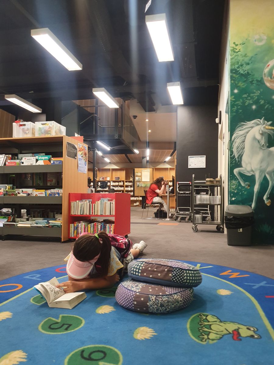 Reading on a library rug