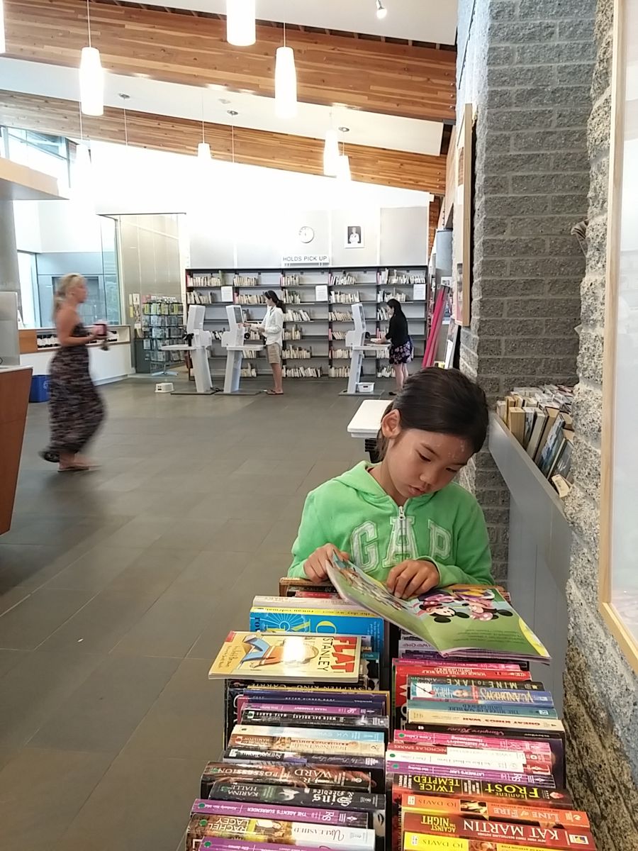Reading at a stack of library books