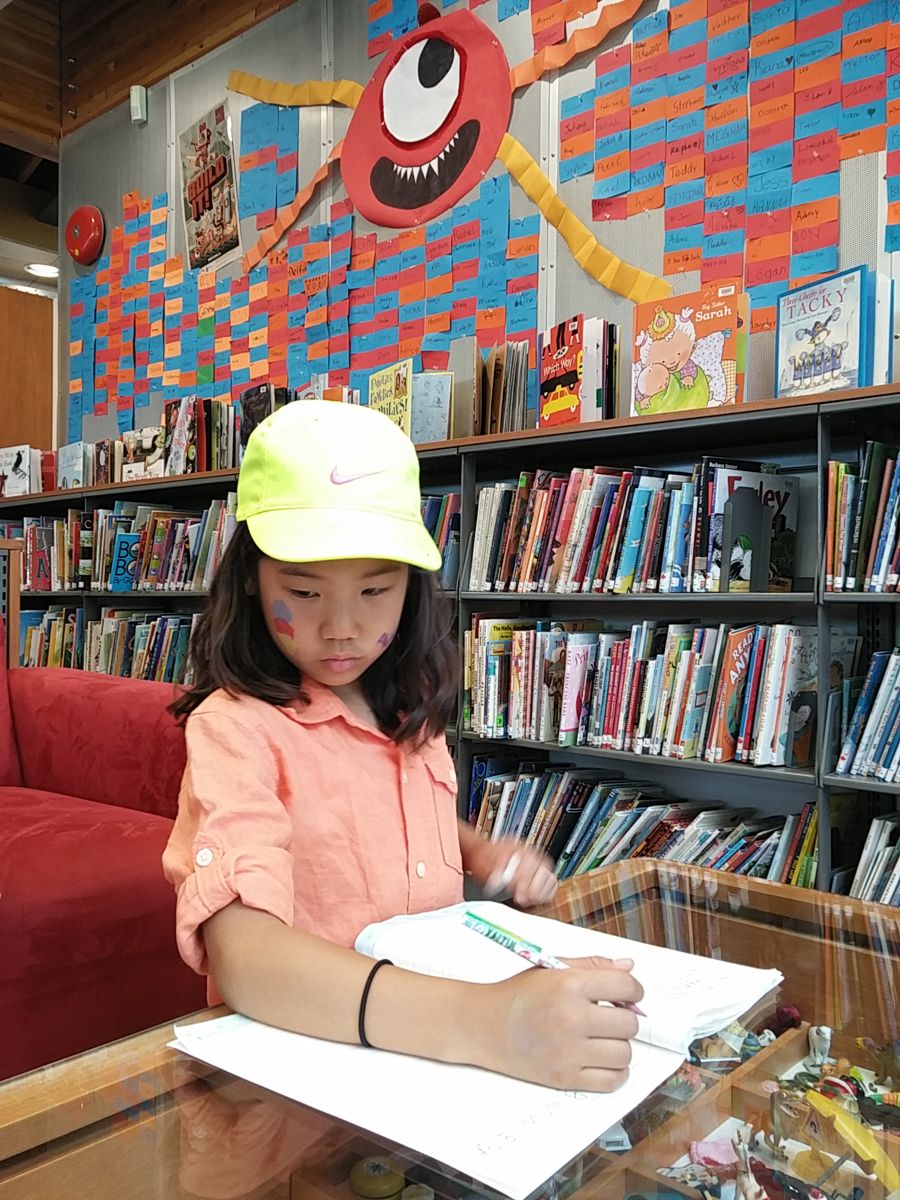 Writing at a library table